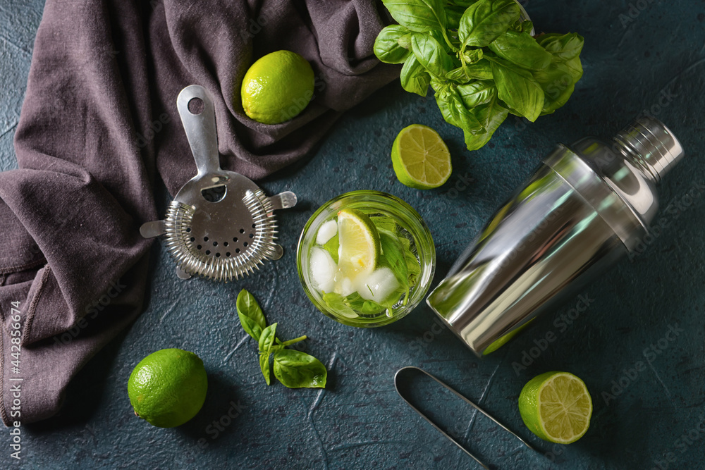 Glass of lemonade with basil on dark background