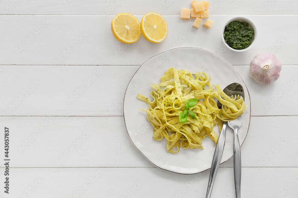 Plate with tasty pesto pasta on table