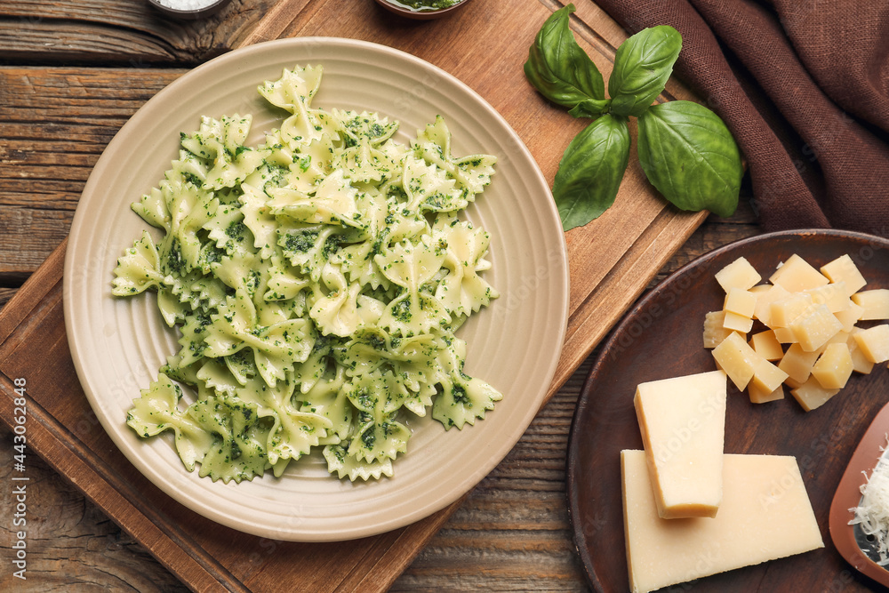 Plate with tasty pesto pasta on table