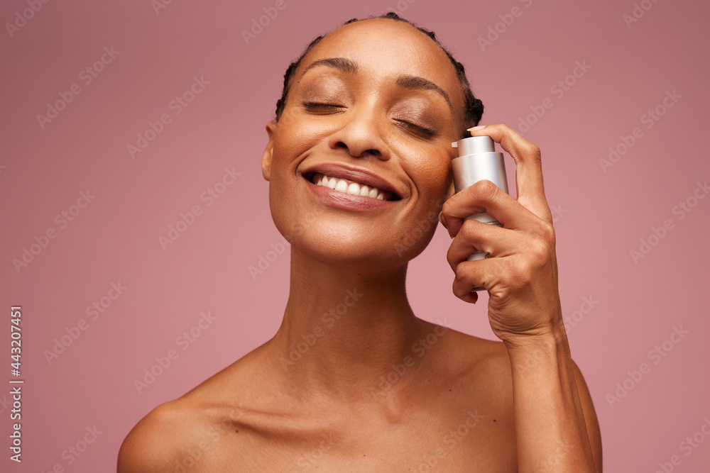 Beautiful woman applying serum to her face