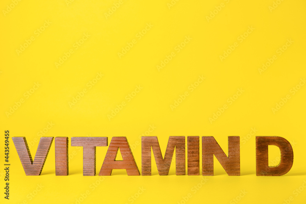 Text VITAMIN D on color background