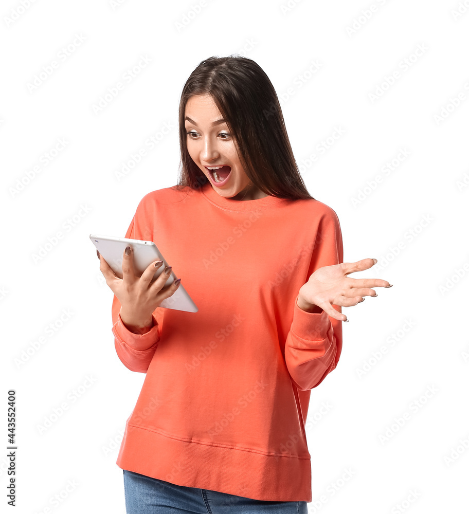 Surprised young woman using tablet computer on white background