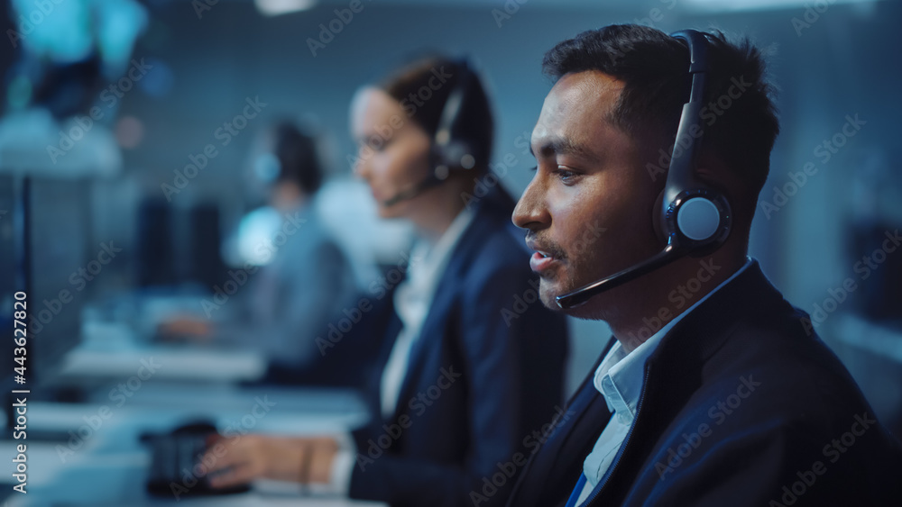 Close Up Portrait of a Joyful Technical Customer Support Specialist Talking on a Headset while Worki