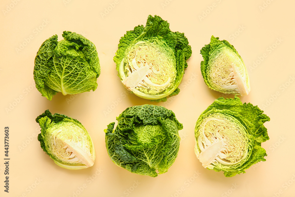 Pieces of fresh savoy cabbage on color background