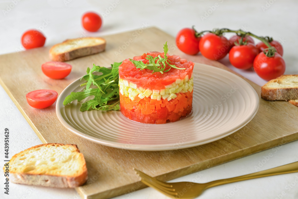 Plate with tasty tartare salad and toasted bread on light background