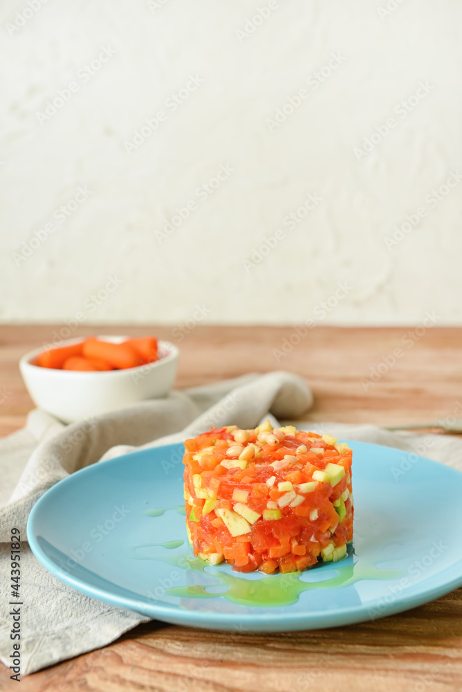 Plate with tasty tartare salad on light background