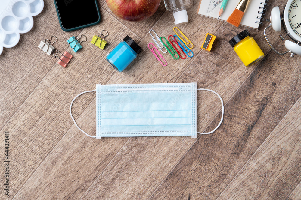 Back to school design concept with stationery over wooden table background.