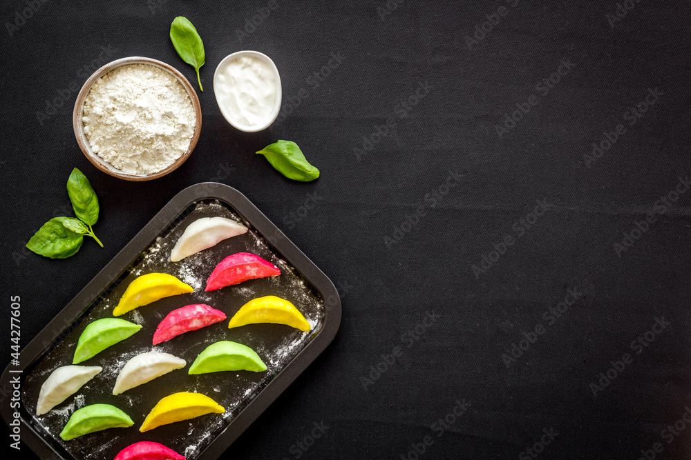 Chinese colorful raw dumplings on baking sheet, top view