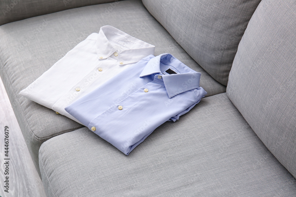 Stylish male shirts on sofa