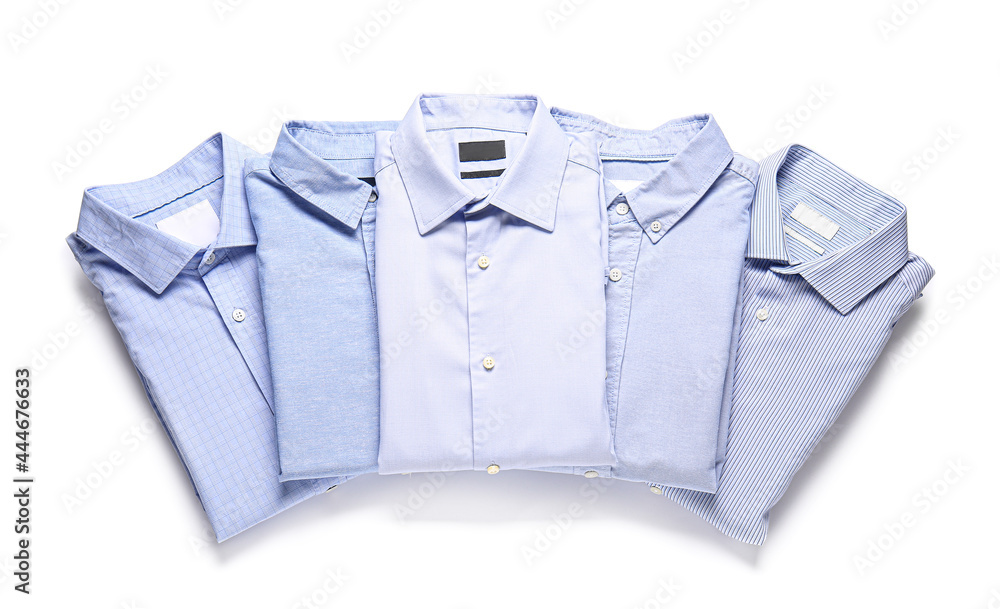 Stylish male shirts on white background