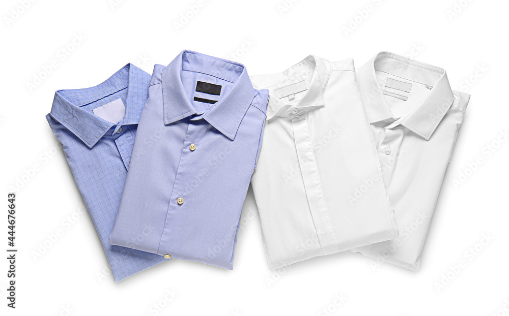 Stylish male shirts on white background