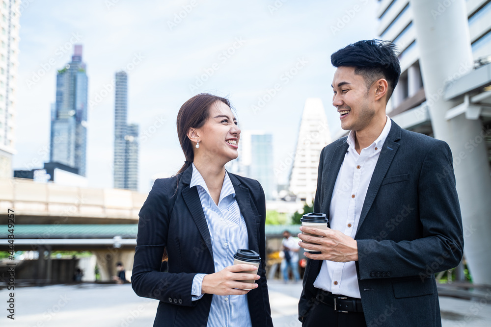 Asian young office businesspeople stand outdoor in city with confident