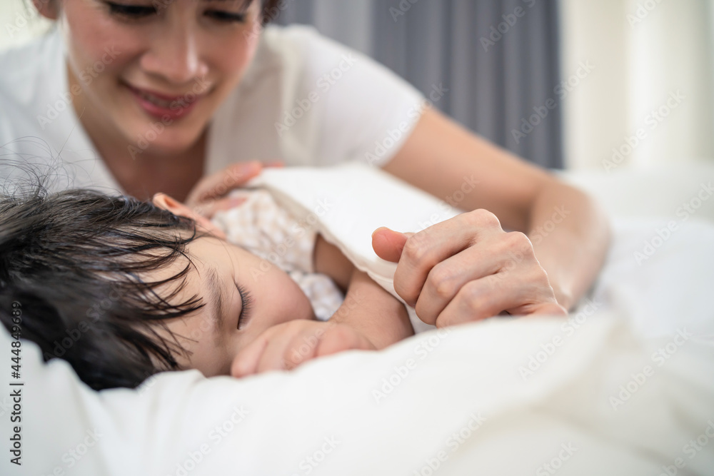 Asian loving beautiful mother take care asleep young comfortable kid. 