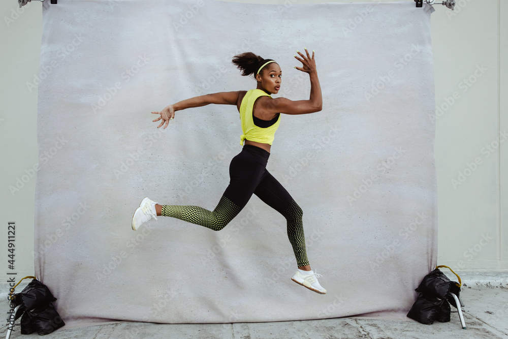 Athlete woman exercising on a building terrace