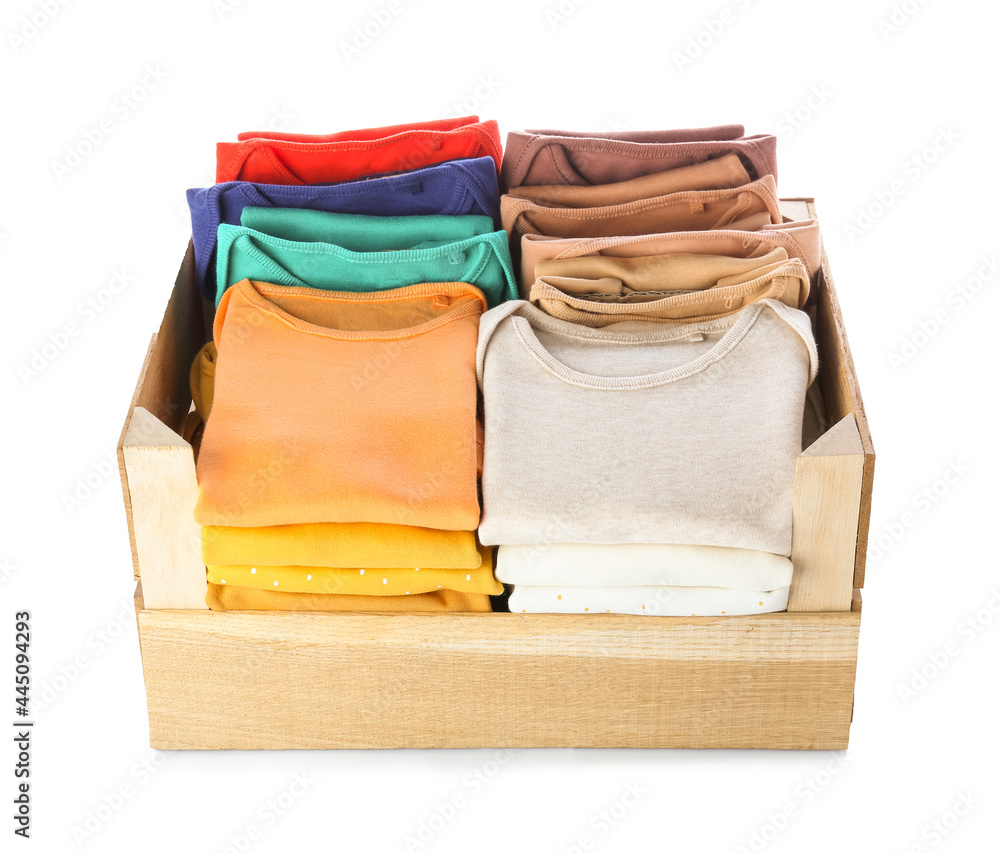 Wooden box with baby clothes on white background