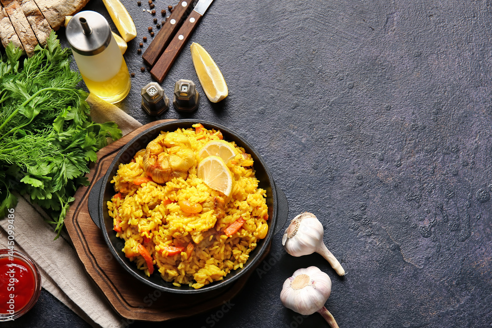 Composition with tasty pilaf on dark background