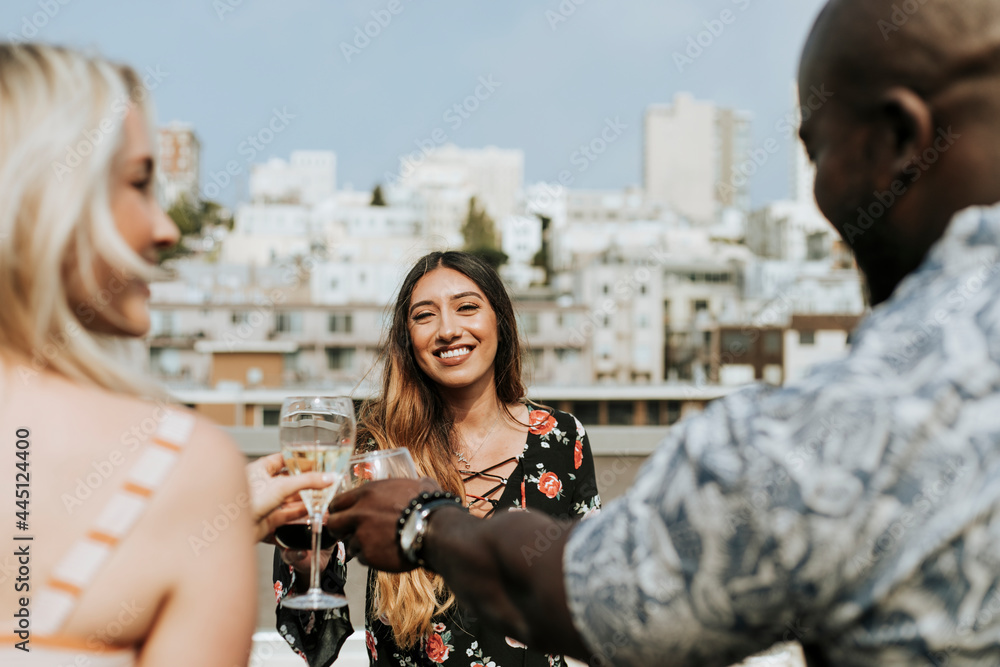 Cheerful friends toasting at a rooftop party