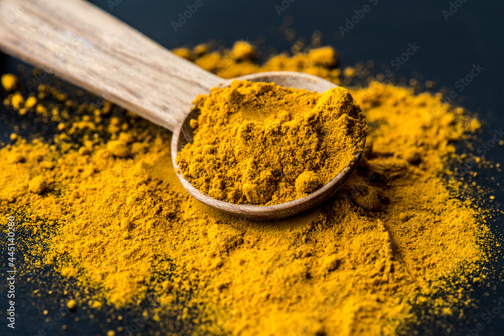 Closeup of tumeric powder spice on a spoon