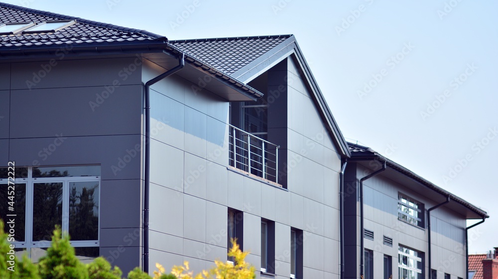 The glazed facade of an office building with reflected sky. Modern architecture buildings exterior b