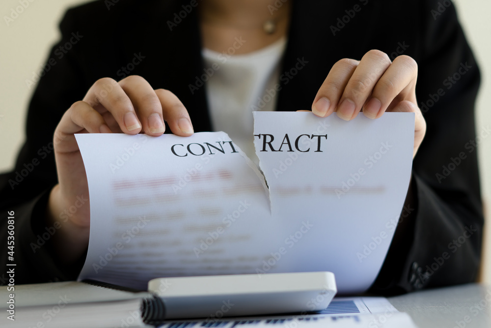 Business woman tearing contract in office