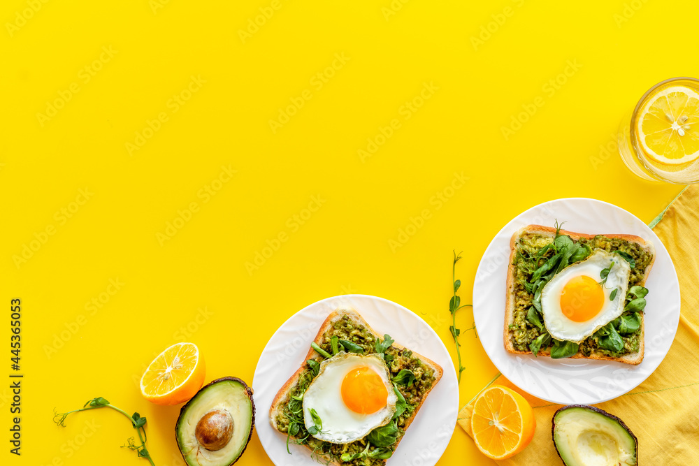 Eggs and avocado with spinach on toasted bread. Top view