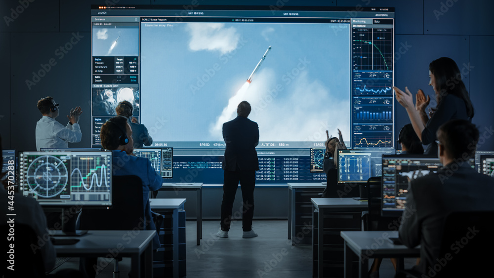 Group of People in Mission Control Center Witness Successful Space Rocket Launch. Flight Director is