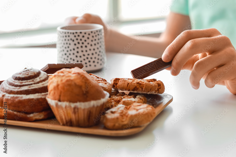 Young man eating sweets at home, closeup