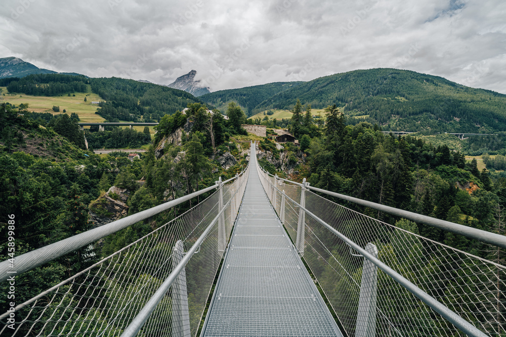 Suspension bridge over Sill river in Mühlbachl, Brenner pass, near Burg Trautson. 