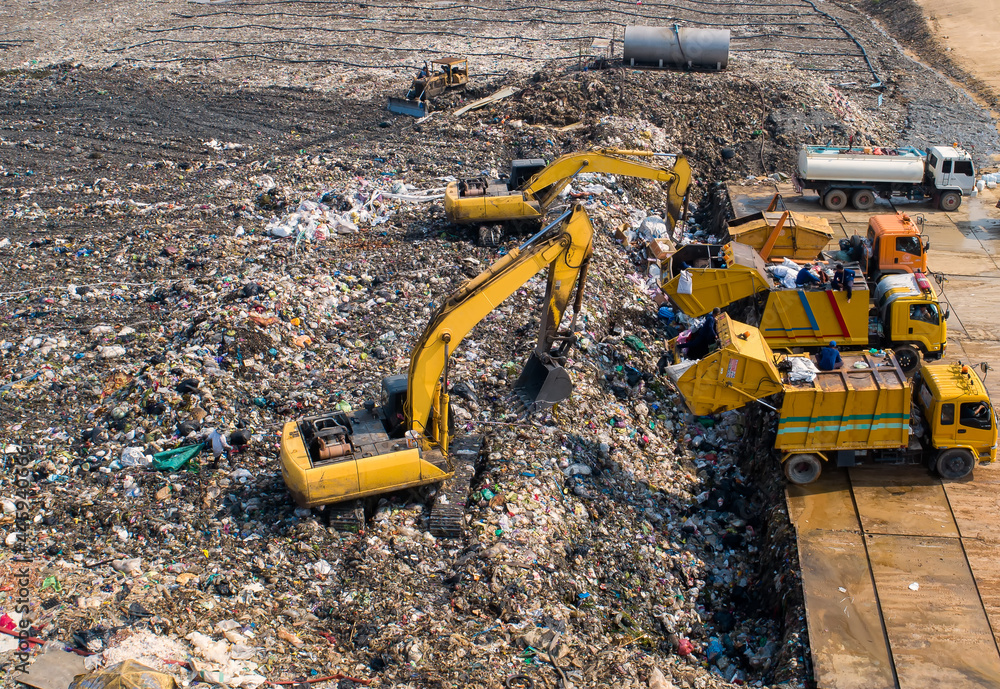 Garbage trucks are working in the waste sorting plant.