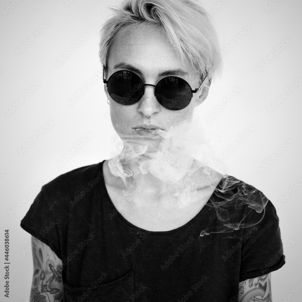 Tattooed woman with a smoke