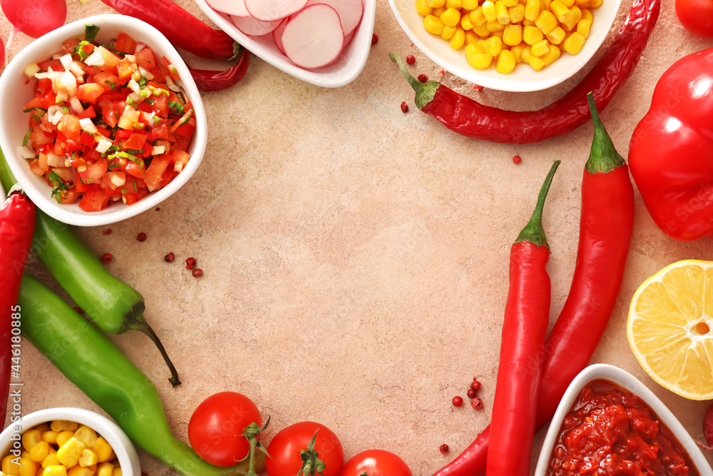 Frame made of tasty salsa sauces with products on color background