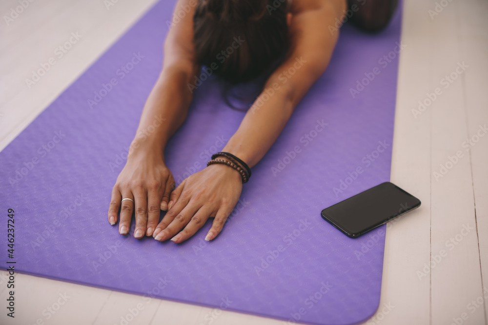 Woman doing stretching workout on exercise mat