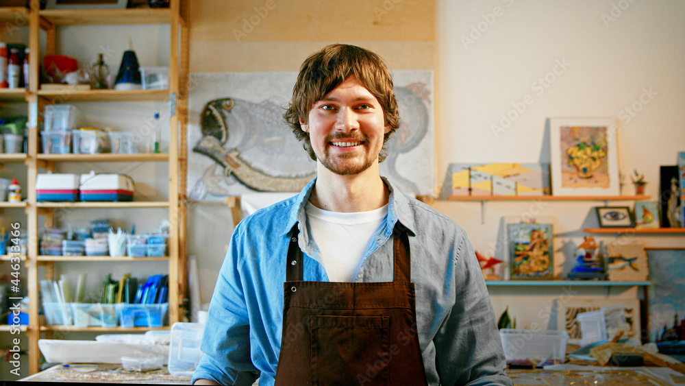 Smiling mature man in an apron looking at camera