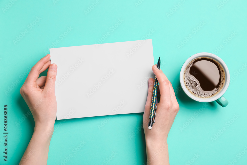 Female hands with blank sheet of paper, pencil and cup of coffee on color background