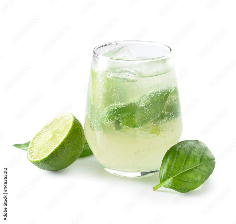 Glass of tasty lemonade with basil on white background