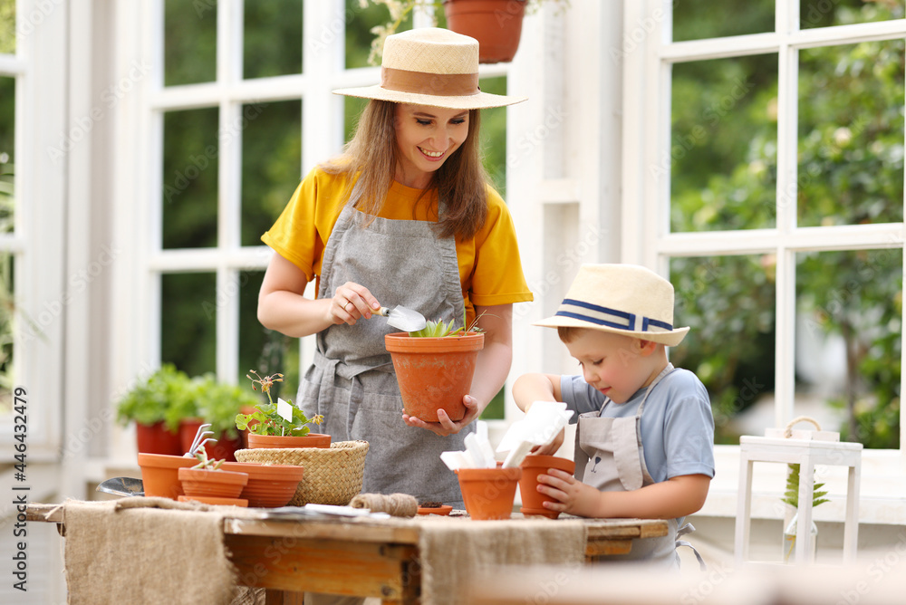 Mother teaching son to grow plants