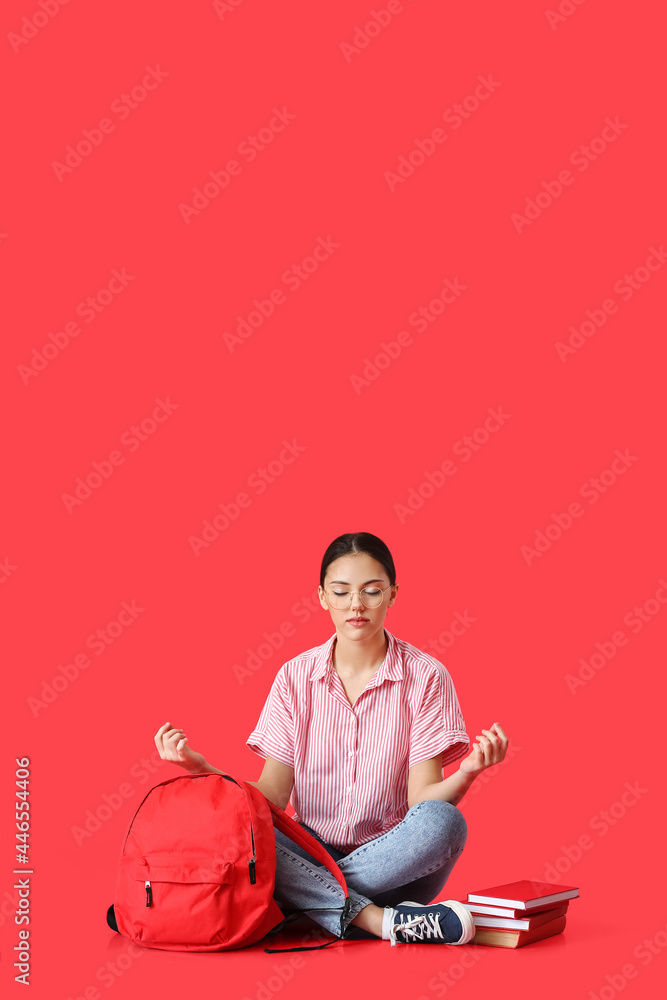 Meditating female student on color background