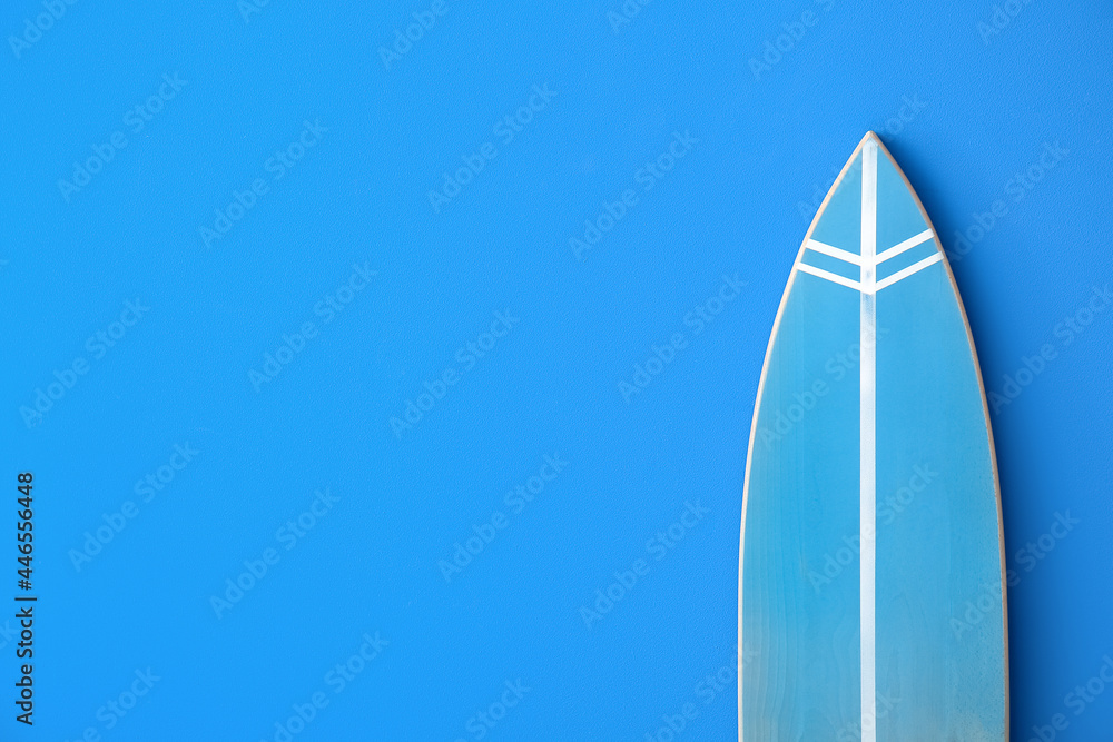 Blue surfboard on color background