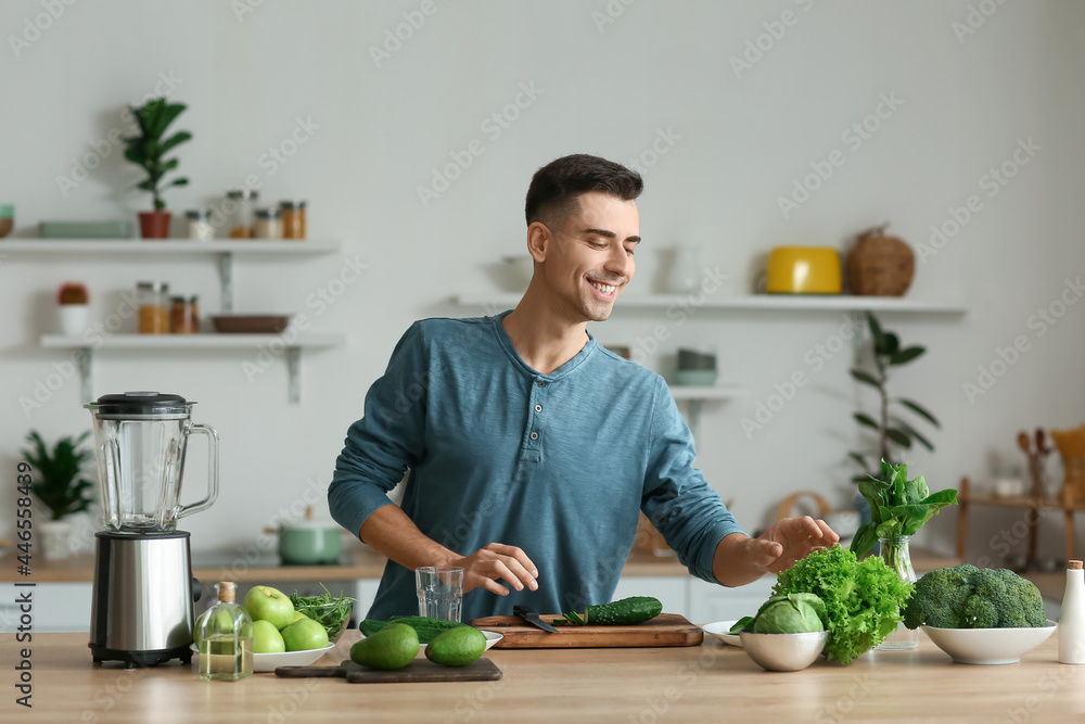 年轻人带着新鲜蔬菜在厨房准备绿色奶昔