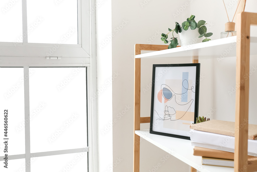 Book shelf with picture near window