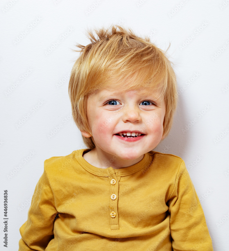 Close portrait smiling laughing little blond boy