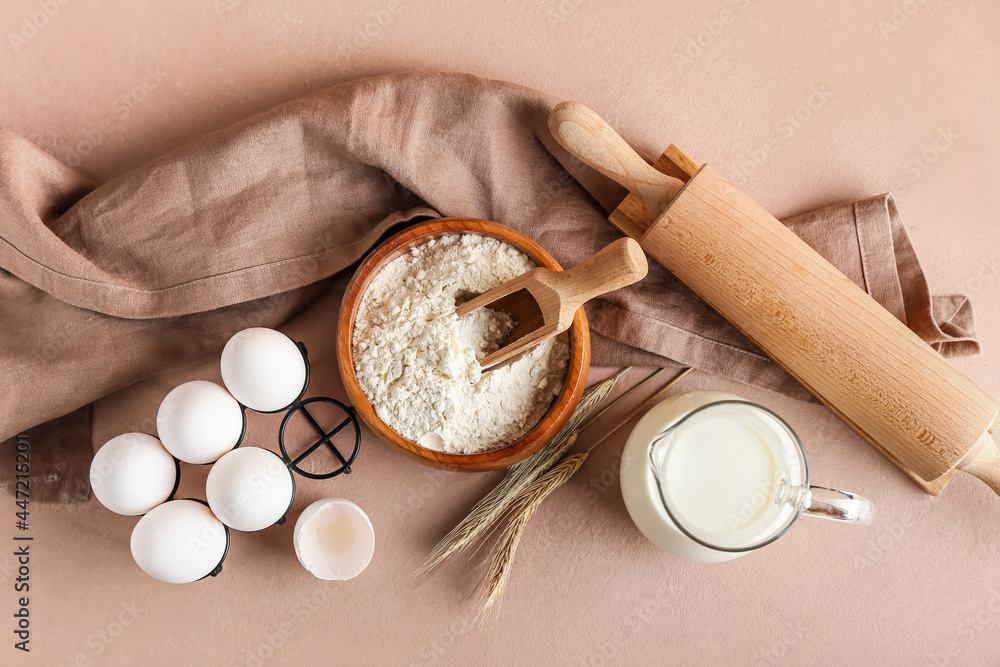 Ingredients for preparing bakery and utensils on color background