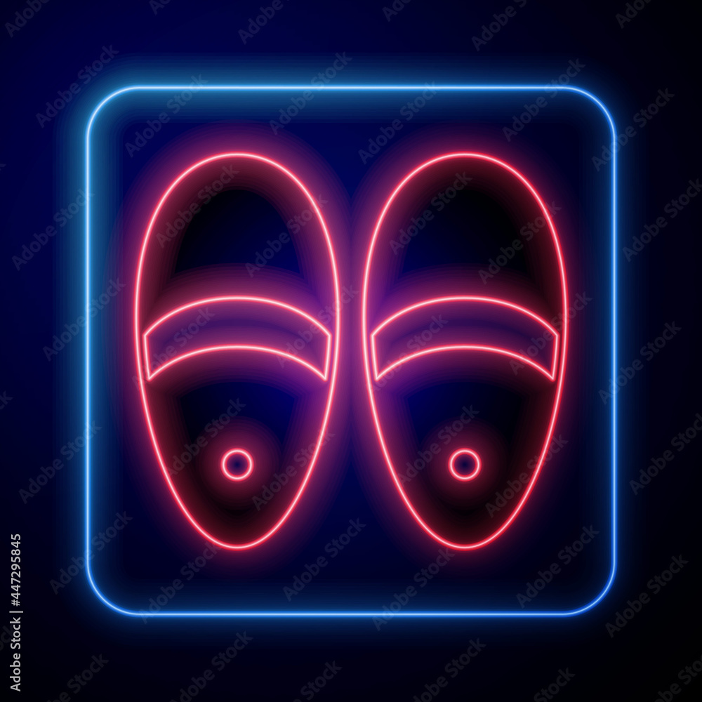 Glowing neon Slippers icon isolated on black background. Flip flops sign. Vector