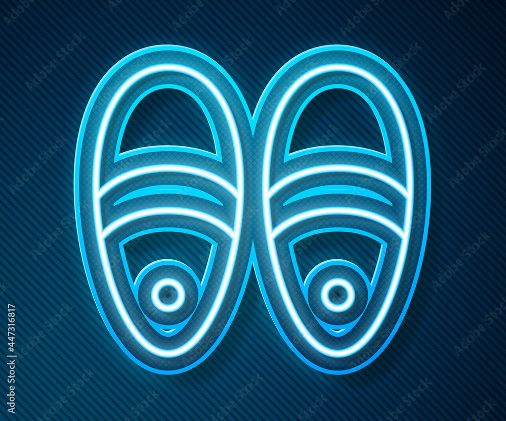 Glowing neon line Slippers icon isolated on blue background. Flip flops sign. Vector