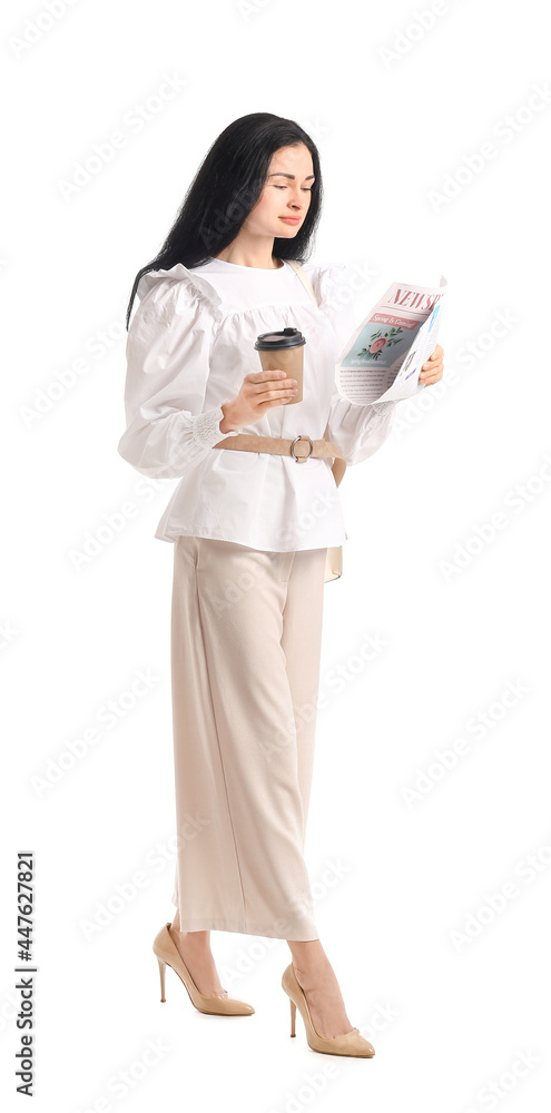 Young woman with cup of coffee reading newspaper on white background