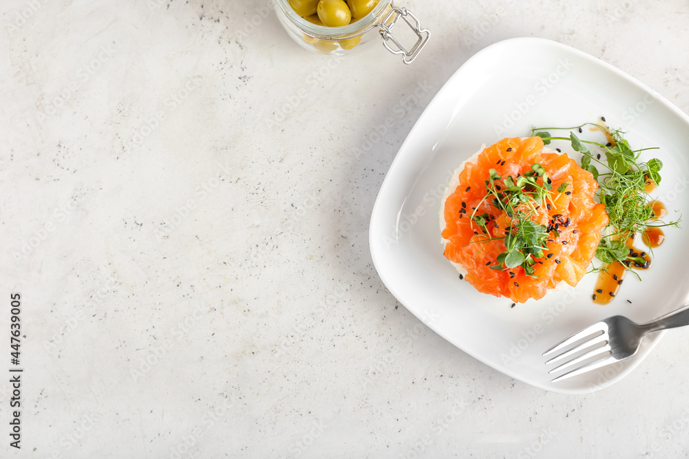 Delicious salmon tartar on light background