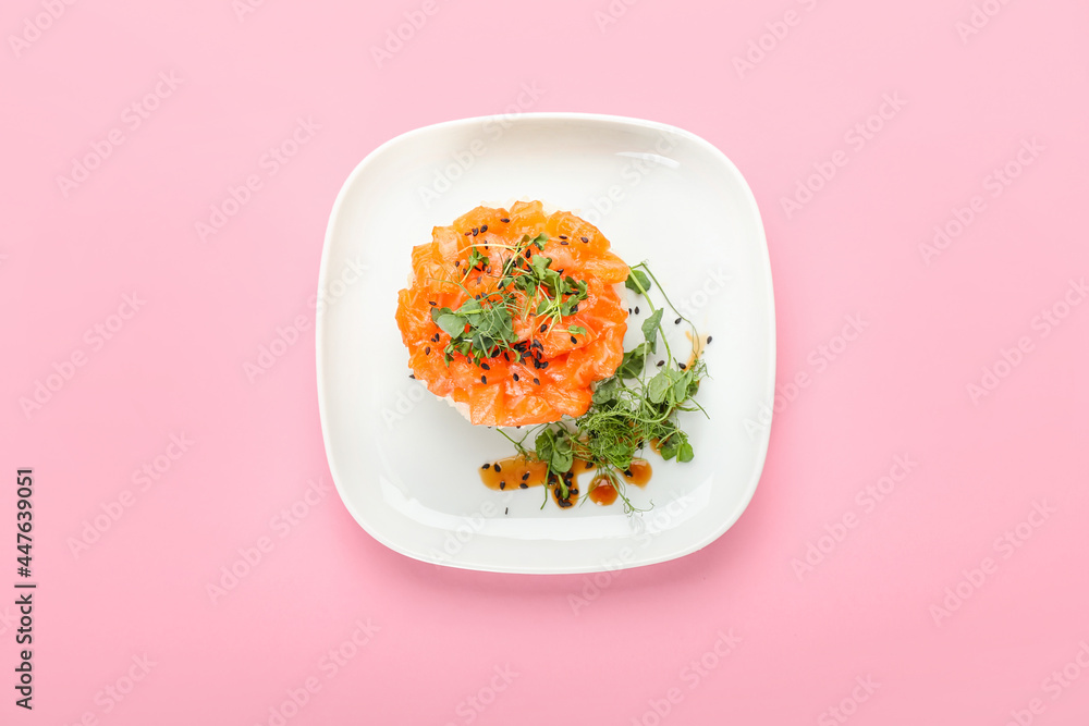 Delicious salmon tartar on color background