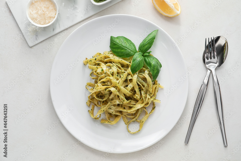 Plate with tasty pesto pasta on table