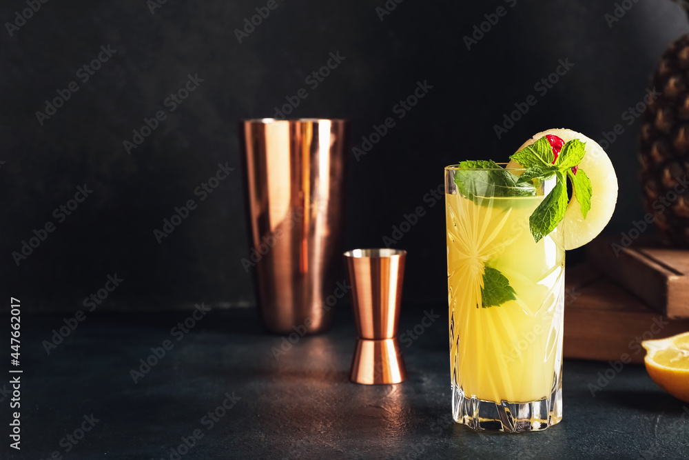 Glass of delicious mai tai cocktail on dark background