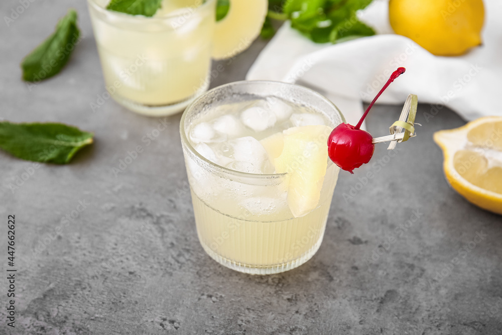 Glasses of delicious mai tai cocktail on grey background